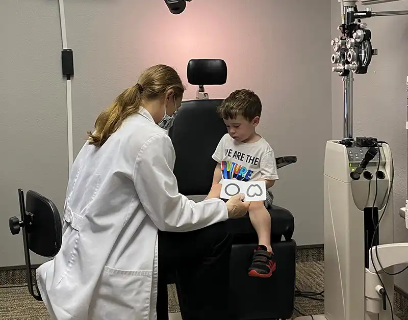 dr carrie kearns giving a pediatric eye exam in waterloo, iowa